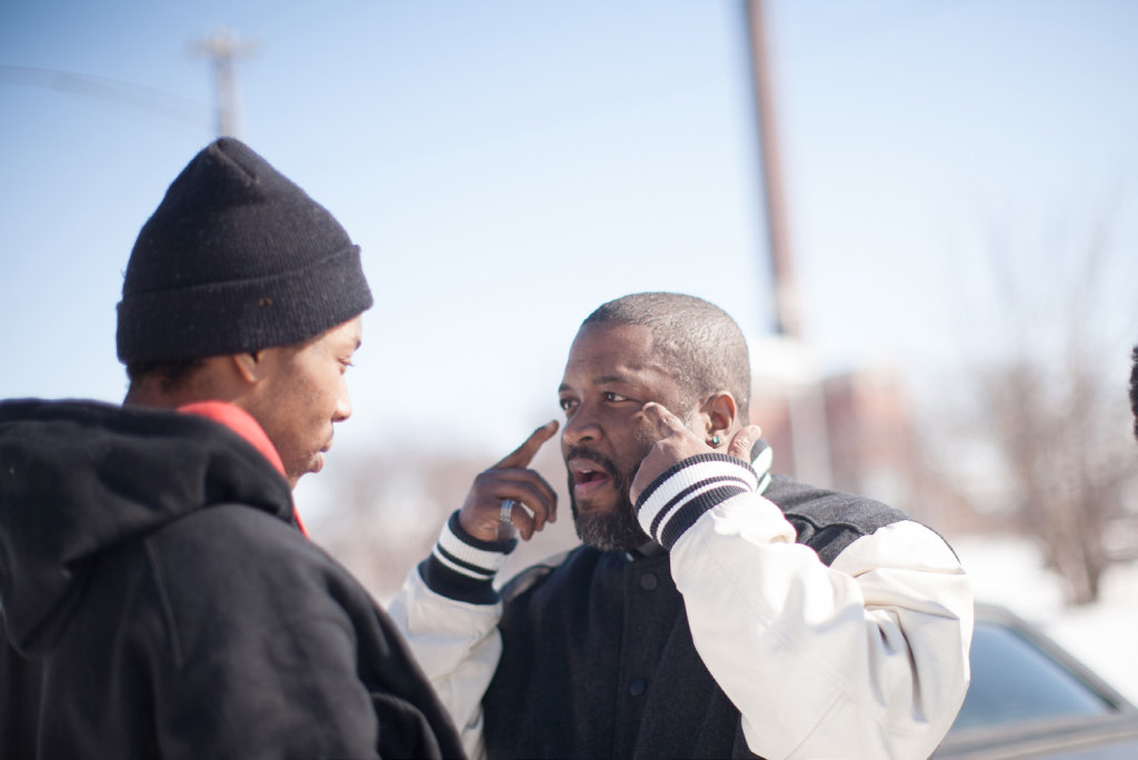 Yusef Shakur (right) counseling a young man. Courtesy photo of NNPA