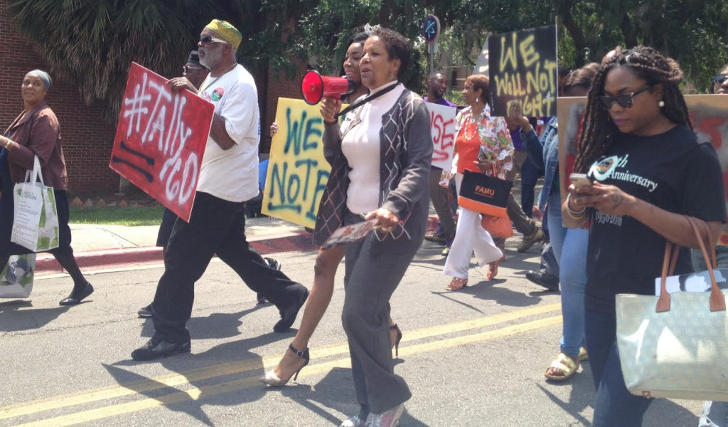 Marchers make their way to Lake Anita where ceremonies were held to celebrate the 60th anniversary of a bus boycott led by FAMU  students Wilhelmina Jakes and Carrie Patterson. Photo by St. Clair Murraine