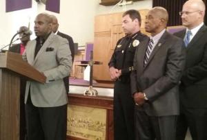 Tallahassee police chief Michael DeLeo and Rev. Lee Johnson listen to pastor Rudy Ferguson during Friday’s press conference.