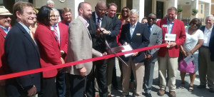 Rev. R.B. Holmes beams with pride as he cuts the ribbon, marking the grand opening of the Frenchtown  Financial Opportunity Center. / Photo by St. Clair Murraine