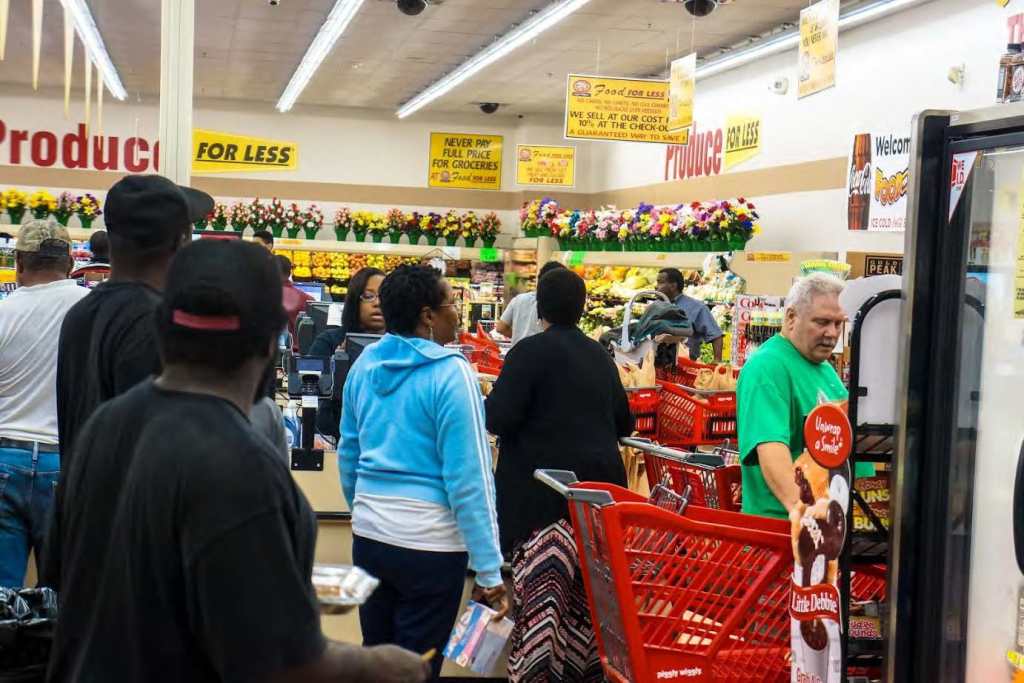 Piggly Wiggly shoppers in line being checked out by store employees. Photo by Elegance Davis 