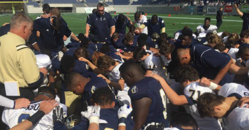 Judge rules against school on football game prayer