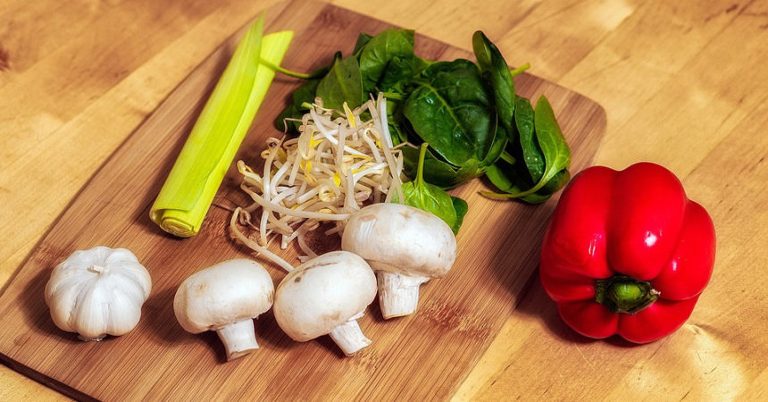 Doctor gives patients veggies with cooking instructions